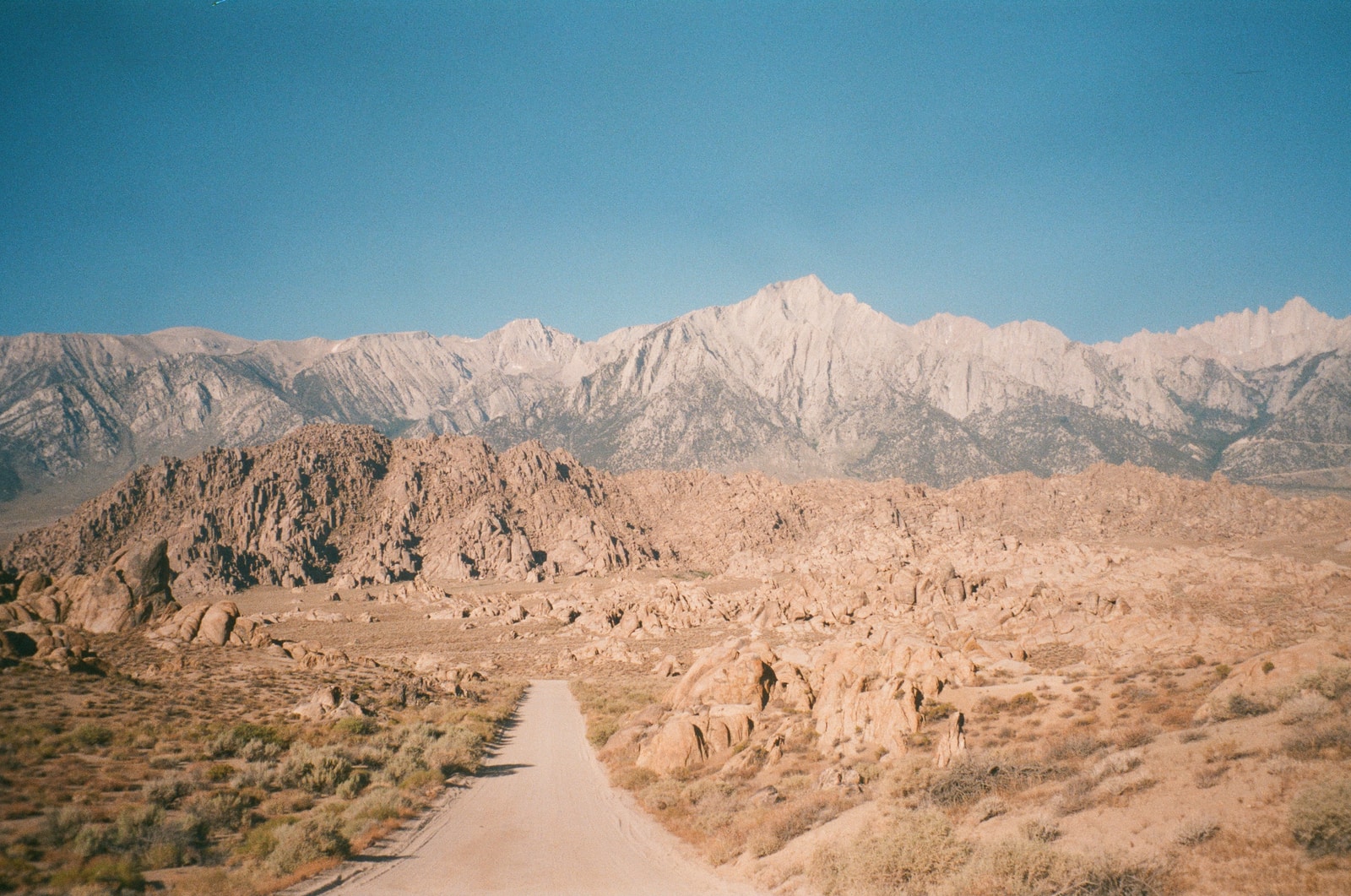 brown sand and gray mountains during daytime